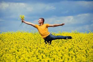 junger Mann mit gelbem Blumenstrauß foto
