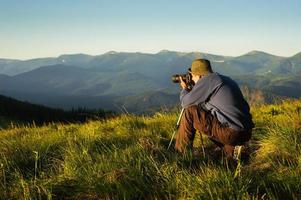 der Fotograf mit Kamera foto