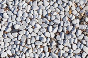 weißer Steinhintergrund, Steine - abstrakter Hintergrund mit runden Kieselsteinen foto