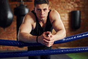 junge boxer in sportlicher kleidung üben im fitnessstudio foto