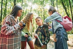 zusammen stehen. kinder im grünen wald im sommer tagsüber zusammen foto