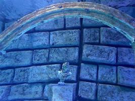 Unterwasserruinen des alten Tempelgebäudes. Lichtstrahlen unter Wasser. Entdeckung des Ozeans. unter wasser meer schatz. versunkene Statue. verlorene stadt atlantis foto