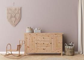 leere Wand im modernen Kinderzimmer. Mock-up-Interieur im Boho-Stil. Kopieren Sie Platz für Ihr Bild oder Poster. Sideboard aus Holz, Korb aus Rattan, Makramee, Spielzeug. gemütliches Zimmer für Kinder. 3D-Rendering. foto