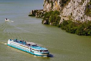 djerdap, serbien, 2021 - kreuzfahrtschiff auf der donau in der djerdap-schlucht in serbien. 2016 besuchten 118 kreuzfahrtschiffe mit mehr als 18.000 touristen den djerdap nationalpark. foto