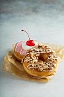 Verschiedene glasierte frittierte Donuts auf Pergament