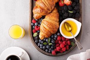 Croissants mit frischen Beeren und Honig foto