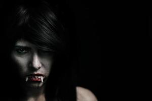 Halloween-Vampir schöne Frau über schwarz foto