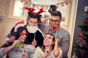 gruppe von freunden, die zu hause weihnachten feiern foto