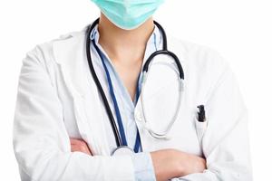 Ärztin gegenüber dem weißen Hintergrund isoliert foto