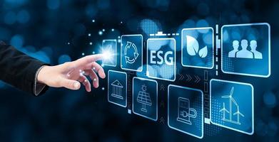 Hand-Touch-Hologramm-Bildschirm, um Energie zu sparen und die globale Erwärmung zu reduzieren, nachhaltige Unternehmensinvestitionen, Kohlenstoffkredite, die Reduzierung von Treibhausgasemissionen, ESG für Umwelt, Soziales und Governance. foto