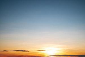 schöne orangefarbene Wolken mit Farbverlauf und Sonnenlicht am blauen Himmel, perfekt für den Hintergrund, nehmen Sie die Abenddämmerung auf foto