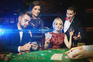 Eine Gruppe reicher Leute spielt Poker im Casino foto