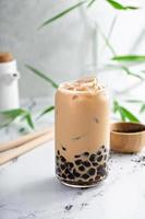 Boba-Milchtee in einem hohen Glas mit Eis foto