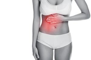 Frau mit schmerzhaften Bauchschmerzen auf weißem Hintergrund foto