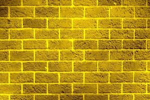 glänzende goldene Backsteinmauerbeschaffenheit, abstrakter Hintergrund, goldenes Muster foto