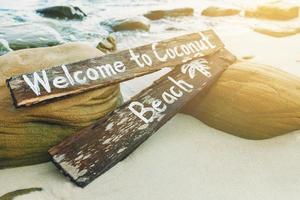 Holzschild mit Schriftzug am Strand foto