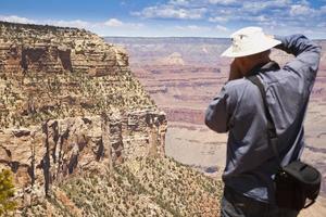 Fotograf, der am Grand Canyon schießt foto