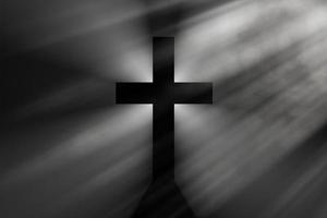 Schwarzes Kreuz in den Lichtstrahlen, einfaches christliches Kreuzzeichen, 3D-Darstellung. foto