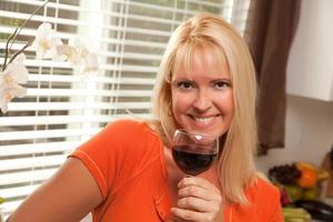 attraktive Blondine mit einem Glas Wein foto