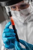 weibliche laborangestellte hält reagenzglas mit blut zum testen. foto