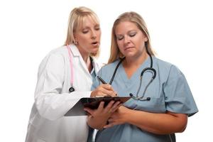 zwei ärzte oder krankenschwestern, die sich eine datei in der zwischenablage ansehen foto