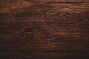 Vintage braune Holzhintergrundtextur mit Knoten und Nagellöchern. alte bemalte Holzwand. brauner abstrakter hintergrund. vintage hölzerne dunkle horizontale bretter. foto