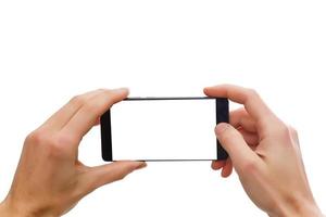 Telefon in handmenschlicher Hand, die ein leeres Smartphone hält, das auf weißem Hintergrund mit Beschneidungspfad für den Bildschirm isoliert ist foto
