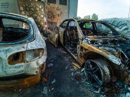 Zwei Autos nach dem Brand. zwei ausgebrannte Autos mit offener Motorhaube. Brandstiftung, verbranntes Auto foto