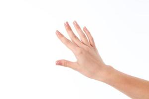 Die weibliche Hand, die mit den Fingern in die Ferne gestreckt wird, ist auf einem weißen Hintergrund isoliert foto