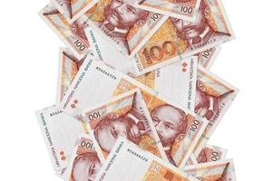 100 kroatische Kuna-Scheine fliegen einzeln auf Weiß herunter. viele banknoten fallen mit weißem copyspace auf der linken und rechten seite foto