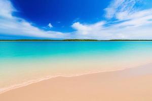 schöner tropischer strand mit blauem ozean. weißer Sand tropisches Paradies Strand Hintergrund Sommerurlaub Konzept. foto