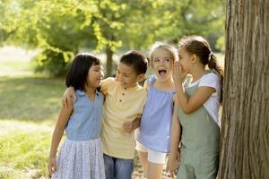 gruppe asiatischer und kaukasischer kinder, die spaß im park haben foto