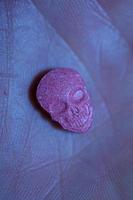 rosa schädel ecstasy pille nahaufnahme hintergrund hochwertiger druck lila armee dope betäubungsmittel substanz hochdosis psychedelische lebensart foto