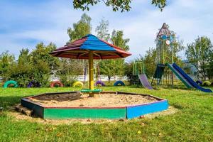 Fotografie zum Thema leerer Sandkasten aus Holz mit Sand für Kinder foto