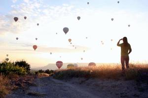 reise nach göreme, kappadokien, türkei. der sonnenaufgang in den bergen mit viel luft heißluftballons am himmel. foto