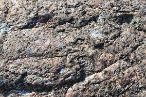 Nahaufnahme einer Granit- und Steinwandstruktur in hoher Auflösung. foto