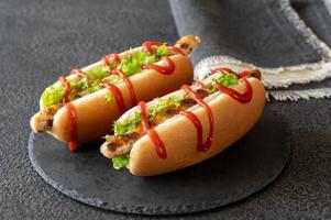 zwei Hot Dogs auf Steinbrett foto