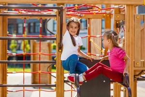 Zwei kleine Mädchen auf dem Spielplatz foto