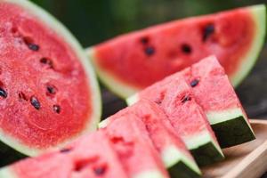 Nahaufnahme frische Wassermelonenstücke tropische Sommerfrüchte - geschnittene Wassermelone auf Holzschneidebretthintergrund foto