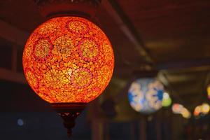 leuchtend rote traditionelle bunte türkische Lampe oder handgefertigte Laterne, selektiver Fokus auf Laterne, unscharfer Hintergrund, beliebte Souvenirlaternen im Café foto