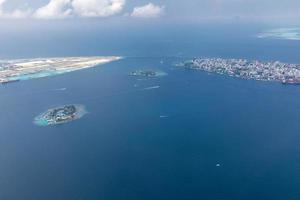 luftbild der malediven inseln und atolle. malediven tourismus und reisehintergrund. erstaunliche Aussicht auf das blaue Meer, das Korallenriff und die Atoll-Drohne. schöne naturlandschaft, seelandschaft, exotisches ziel foto