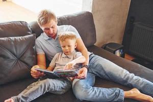 Vater und Sohn lesen zusammen foto