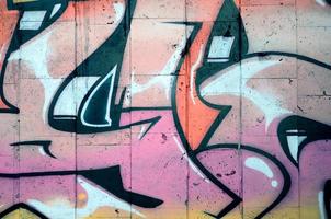 ein Fragment eines detaillierten Graffitis einer Zeichnung, die mit Aerosolfarben auf einer Wand aus Betonfliesen erstellt wurde. Hintergrundbild der Straßenkunst in beigen und rosa Farbtönen foto
