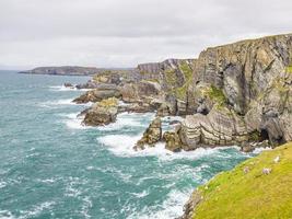 Schroffe Steilküste am Mizen Head Lighthouse im Südwesten Irlands tagsüber foto