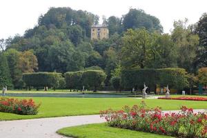 reise nach salzburg, österreich. der blick auf den park in der nähe des gebäudes mit bunten blumen am sonnigen tag. foto