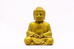 Buddha-Miniatur auf weißem Hintergrund foto