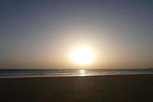 sonnenuntergang über dem meer, sonnenuntergang im herbst am strand von zahara de los atunes, cadiz, andalusien, spanien foto