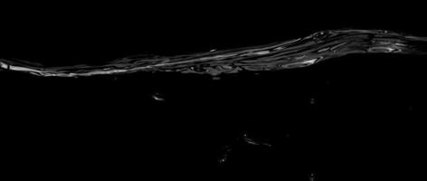 flüssige Oberflächenlinie zwischen Unterwasser und über Wasser mit schwarzem Hintergrund. foto
