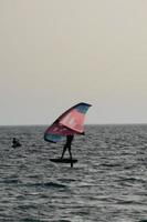 Windsurfen, Kitesurfen, Wasser- und Windsport mit Segeln oder Drachen foto