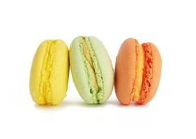 drei mehrfarbige runde gebackene Macarons-Kuchen isoliert auf weißem Hintergrund foto